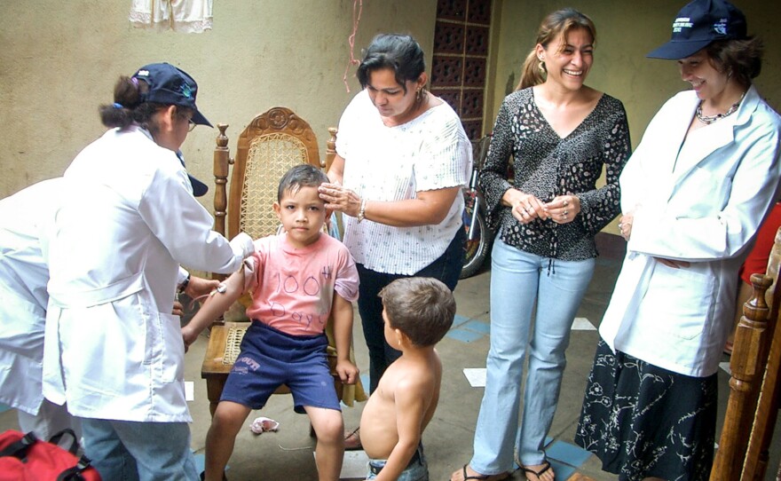 Researchers draw blood from a boy enrolled in the dengue study at a clinic in Managua, Nicaragua.