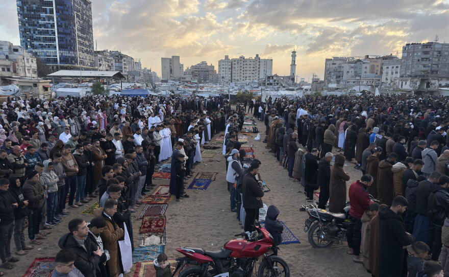 Palestinians gather in an open space in Gaza City for early morning prayers that mark the end of the Muslim holy month of Ramadan on March 20, 2026.