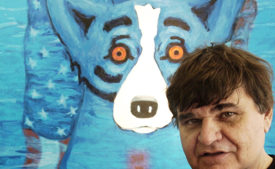 Artist George Rodrigue with one of his iconic "Blue Dog" paintings