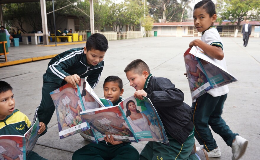 Students engage in a class project at the Escuela 20 Noviembre school in Tijuana, Mexico.