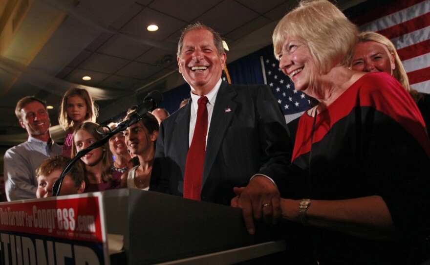 Bob  Turner, center, joined by his wife Peggy,  right, and family smiles as he  delivers his victory speech during an  election night party in New York.  Turner says his shocking win in a heavily Democratic New York City district is a "loud and clear" message to Washington.