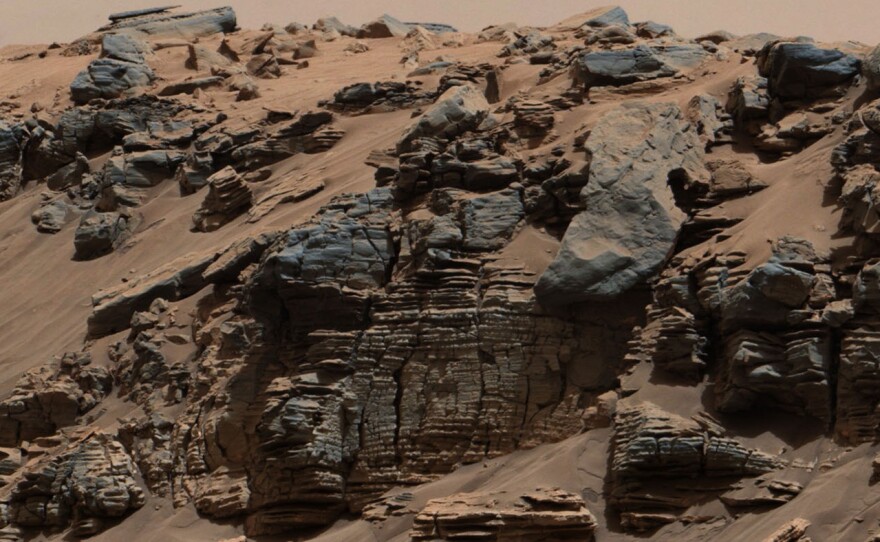 Layers of rock in this image taken at the edge of "Hidden Valley" on Mars suggests "a lake-floor sedimentary deposit not far from where flowing water entered a lake," NASA says.