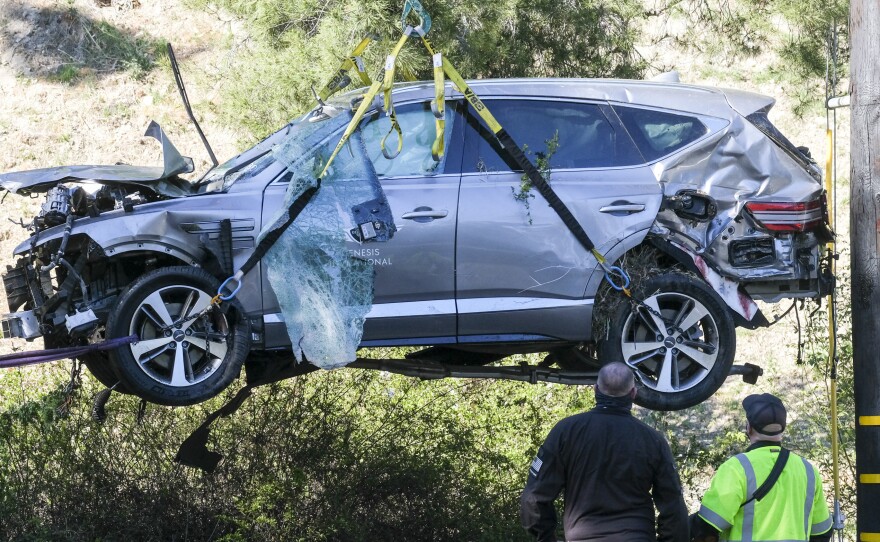 A crane is used to lift a vehicle driven by golfer Tiger Woods following a rollover accident in the Rancho Palos Verdes area of Los Angeles.