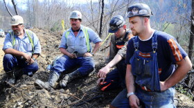 Massey Energy workers take a break from drilling efforts above Massey Energy's Upper Big Branch Coal Mine in Montcoal, W.Va., on April 7. Two days before, an explosion in the mine killed 29 workers. A recent investigation shows evidence of excess coal dust, a possible facilitator of the blast.