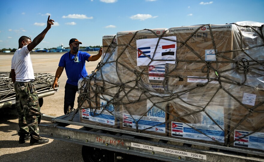 Workers at Havana's airport prepare a shipment of Cuba's Soberana Plus vaccine against COVID-19. The government is donating the doses to Syria.