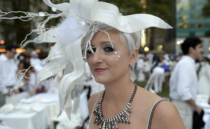Many guests see Diner en Blanc as an occasion to unleash their fashion whimsy. The event is always held outdoors, always at a landmark location revealed at the last-minute. Here, a guest at the Bryant Park event last week.
