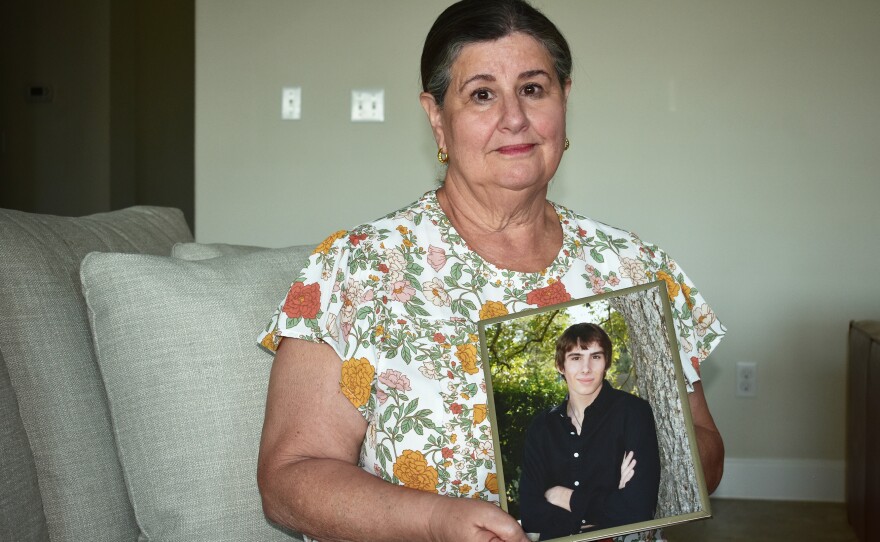 Sue Phillips holds a photograph of her son, Matthew. He died after two members of a white supremacist gang beat him until he was unconscious in a recreation cage at Thomson.