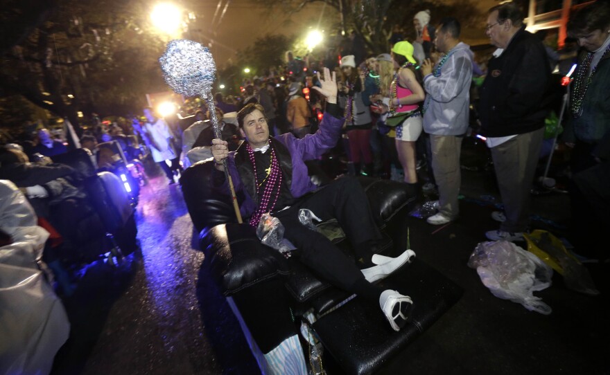 Monday: Members of the Laissez Boys Pleasure Aid & Leisure Club parade during the Krewe of Orpheus parade.