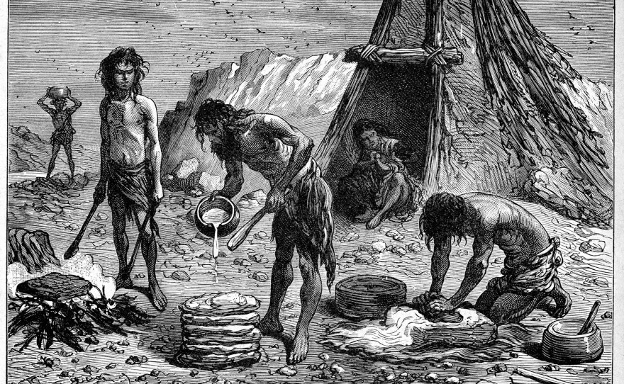 Early humans preparing food — depicted in an engraving from "Grands Hommes et Grands Faits de l'Industrie" circa 1880.