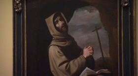 An oil painting titled "Saint Francis in Prayer in a Grotto" by Francisco de Zurbaran is displayed at the San Diego Museum of Art. 