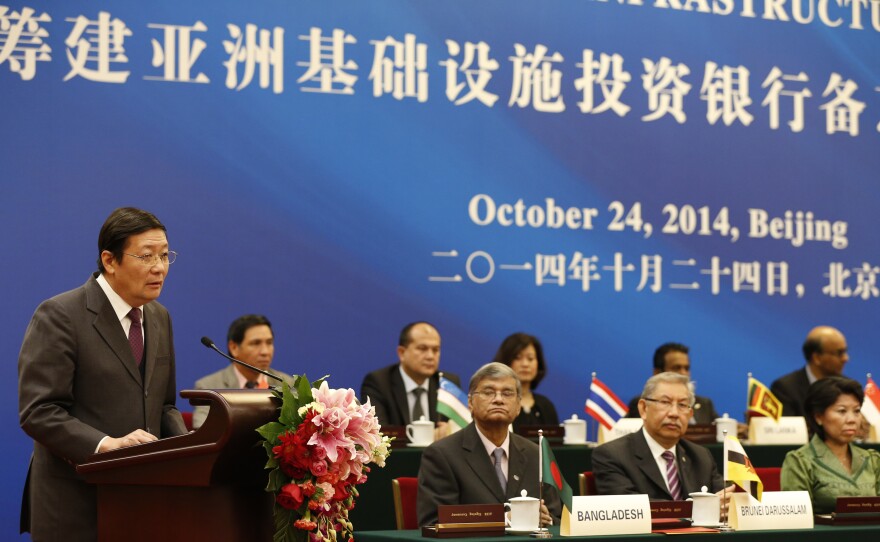 Chinese Finance Minister Lou Jiwei (left) speaks during the signing ceremony of the Asian Infrastructure Investment Bank, Oct. 24, in Beijing.
