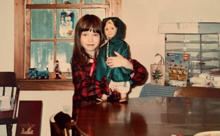 Jessica as a child with an American Girl doll.