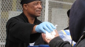 A D.C. Central Kitchen employee gives out food to people in need in Washington. Aid organizations have seen a spike in the number of people who don't have enough food.