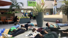 Teens and adults held a "die-in" at U.S. Rep. Scott Peters office on Friday calling him to support the Green New Deal.