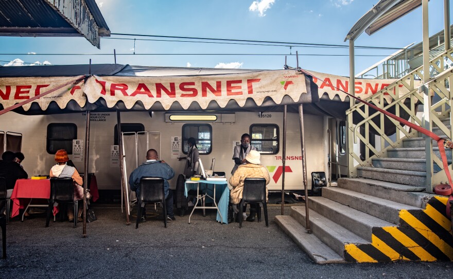 Patients get their eyes tested by medical staff outside the Phelophepa health-care train in Kroonstad, South Africa.