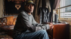 Calvin Neal sits inside his single-room occupancy at the Hotel Churchill in downtown San Diego on Friday, Oct. 3, 2025.