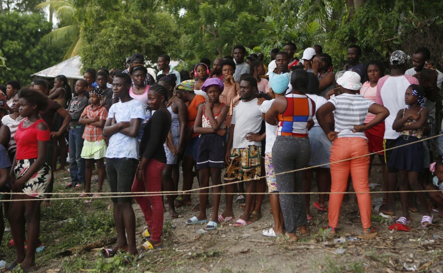 Families wait to receive humanitarian aid from a U.S. Army helicopter unit in the town of Anse-A-Veau, Haiti, on Wednesday.