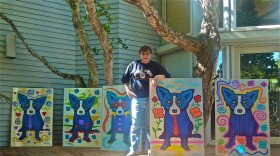Artist George Rodrigue poses with some of his Cajun heritage paintings.