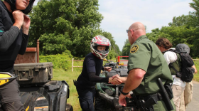 A U.S. Border Patrol agent greets an undercover officer from Canada's federal
police, the RCMP, in Vermont, steps inside the US. The two agencies jointly
patrol this section of the border. 