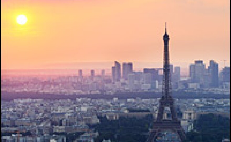The sun sets behind the Eiffel Tower on June 10 in Paris.