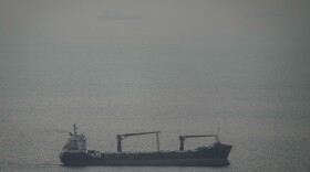 A cargo ship carrying vehicles sails through the Arabian Gulf toward the Strait of Hormuz in the United Arab Emirates, Sunday, March 22, 2026.