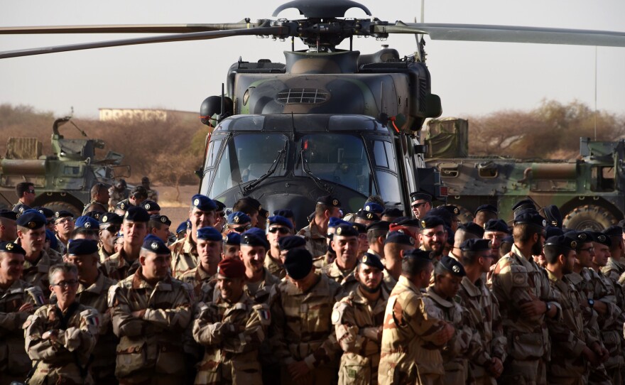 French soldiers listen to the country's defense minister in January of this year at a French base outside the northern Mali city of Gao. The French military routed a radical Islamist group from large parts of northern Mali in 2013 and have remained to assist the government. French troops are currently in five former colonies in Africa backing the governments.