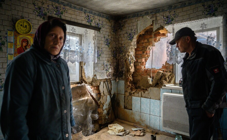 <strong>April 19:</strong> Tanya Los, 57, (left) and her husband, Valery, stand in their house near damage caused by a rocket that landed on Sunday and was believed to have been launched from a Soviet-era BM-27 Uragan launcher based on serial numbers, in the village of Mala Tomachka near the southern front of fighting between Ukrainian and Russian forces, south of Zaporizhzhia.