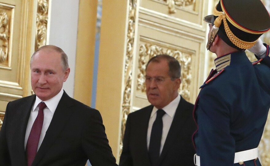 Russian President Vladimir Putin and Foreign Minister Sergei Lavrov walk past honour guards at the Kremlin in Moscow. U.S. sanctions are targeting Putin and a handful of individuals believed to be among his closest advisors.