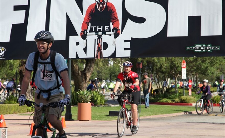 Damian Kevitt rolls through the finish line a year after a horrific hit-and-run crash that resulted in him losing a leg.