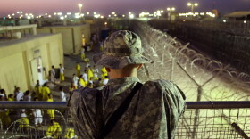 A U.S. Army soldier watches Iraqi detainees at the Camp Cropper detention center September 19, 2007 in Baghdad, Iraq. 
