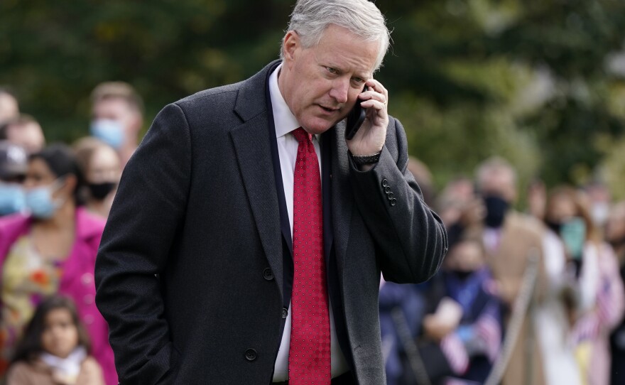 FILE - White House chief of staff Mark Meadows speaks on a phone on the South Lawn of the White House in Washington, on Oct. 30, 2020.