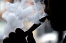 In this April 23, 2014 file photo, a man smokes an electronic cigarette in Chicago.