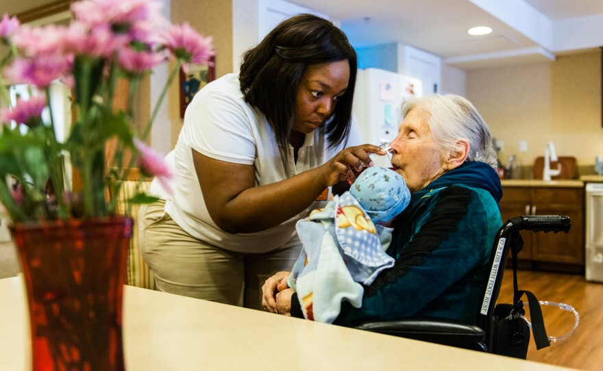 Marilou Roos, 87, rarely speaks and sleeps much of the day. But caregiver Jessica Butler says Roos brightens up when caring for the dolls.
