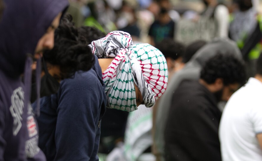 People sit in prayer at a protest for Gaza at UCSD in San Diego, Calif. March 6, 2024.