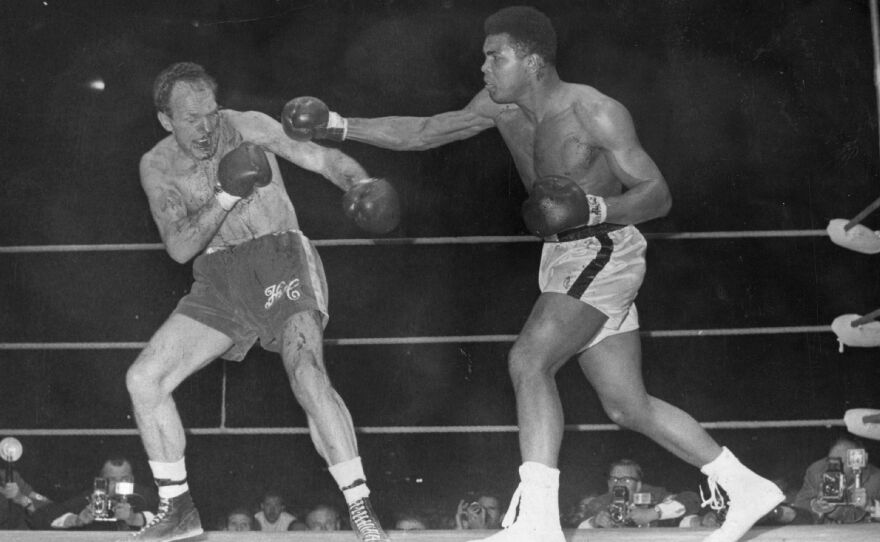 American boxer and world heavyweight champion Muhammad Ali throws a long right to British challenger Henry Cooper's injured left eye in the sixth round of their world heavyweight championship fight.