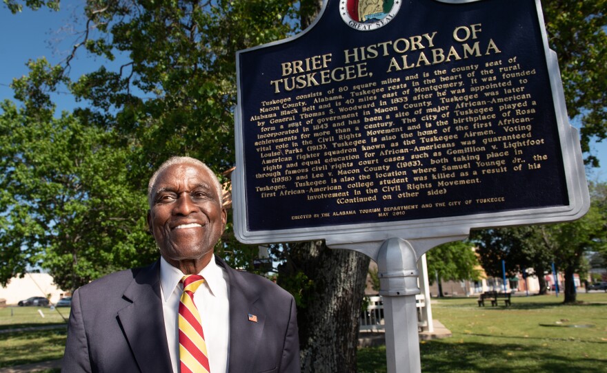 Johnny Ford, former mayor of Tuskegee, Ala., and a current council member, stands near an accurate historical marker that was installed in the town square during his term as mayor. Ford is currently fighting to have a Confederate marker and statue removed from the square.