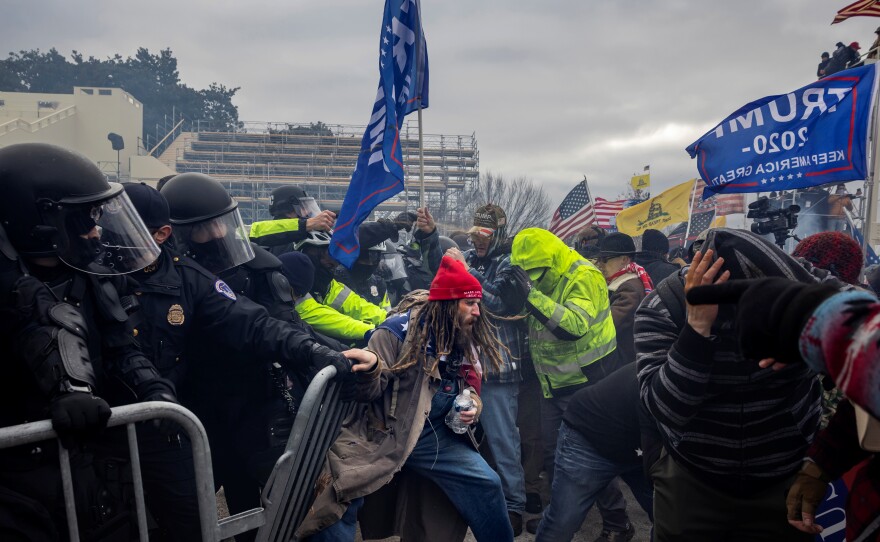 Trump supporters clash with police outside of the U.S. Capitol on Jan. 6, 2021. Social media companies are under scrutiny for allowing their platforms to be used to spread falsehoods about the 2020 election and to allow violent extremist groups to organize January's insurrection.
