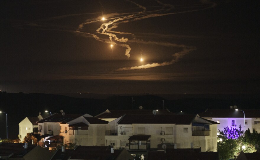 Flares rise over the Gaza Strip as seen from southern Israel on Monday.