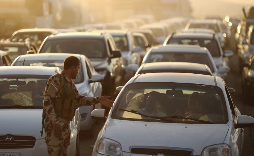Cars pack a Kurdish checkpoint as residents flee Mosul in northern Iraq. The city was overrun by Islamic militants last week.