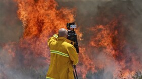 KPBS videographer Christopher Maue shoots near the Vallecito Lightning Complex wildfires on August 15, 2012.