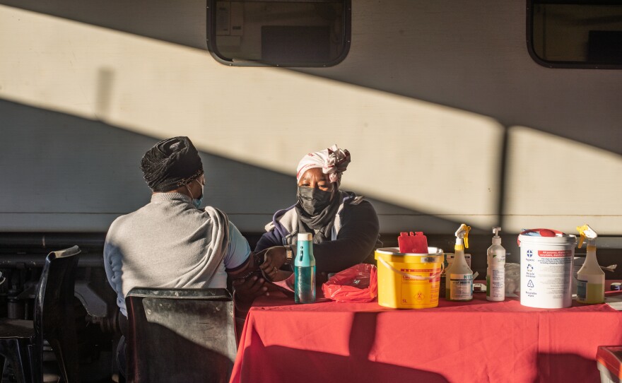 A nurse takes a patient's vital signs in the early morning at the Phelophepa in Thaba Nchu, South Africa.