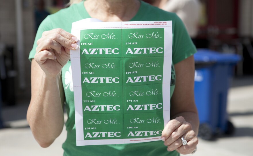 This woman handed out stickers celebrating both the Aztecs and St. Patrick's Day. 