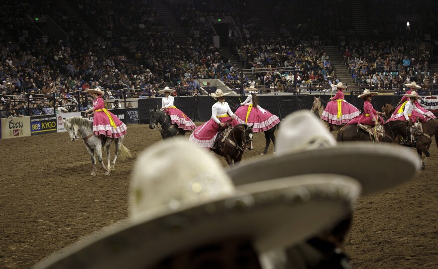 Escaramuza Flor de Aguileña perform a sidesaddle synchronized routine for the audience.