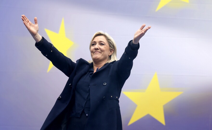 Marine Le Pen, France's National Front political party leader, reacts as she attends their traditional rally in Paris on Thursday.