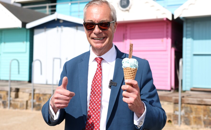 Britain's Reform Party leader Nigel Farage enjoys an ice-cream after casting his vote at a polling station in Walton on the Naze, England, Thursday, May 7, 2026.
