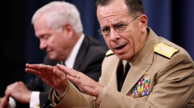 Adm. Mike Mullen (right), chairman of the Joint Chiefs of Staff, accompanied by Defense Secretary Robert Gates, attends a news conference at the Pentagon on June 18.