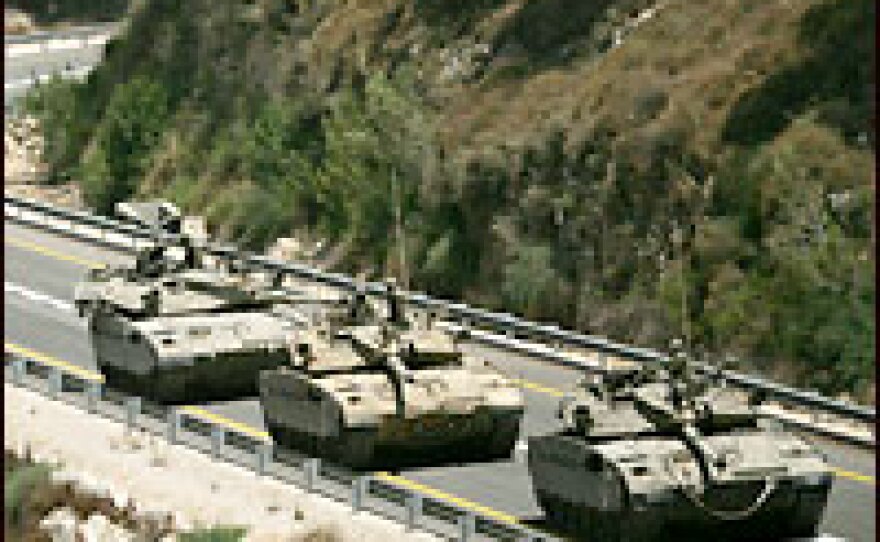 A convoy of Israeli tanks prepares to enter southern Lebanon near the northern Israeli village of Avivim.