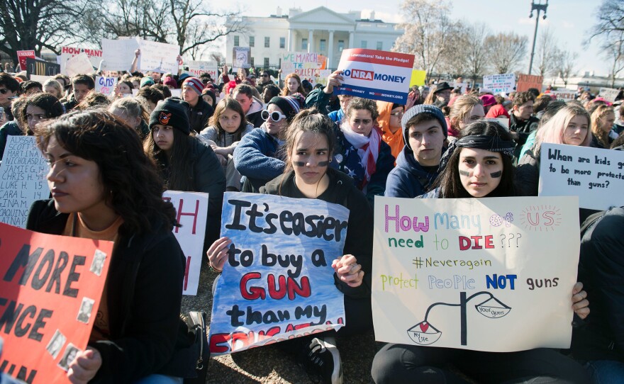 Thousands of local students sit for 17 minutes in honor of the 17 students killed last month in a high school shooting in Florida, during a nationwide student walkout for gun control in front the White House in Washington, D.C.
