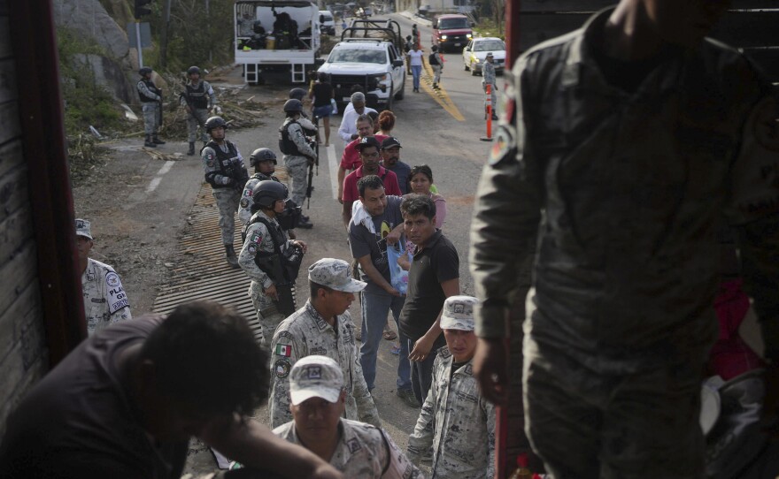 <strong>Oct. 28:</strong> Soldiers stand guard during a food delivery, in the aftermath of Hurricane Otis in Acapulco, Mexico.