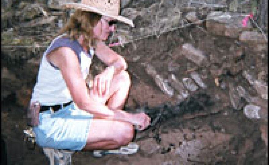 Archaeologist Kristen Kuckelman kneels in one of the ancient houses, or kivas, at Goodman Point Pueblo.  Her research points to climate change as contributing to the disappearance of the Anasazi, or Pueblo People of the Southwest.